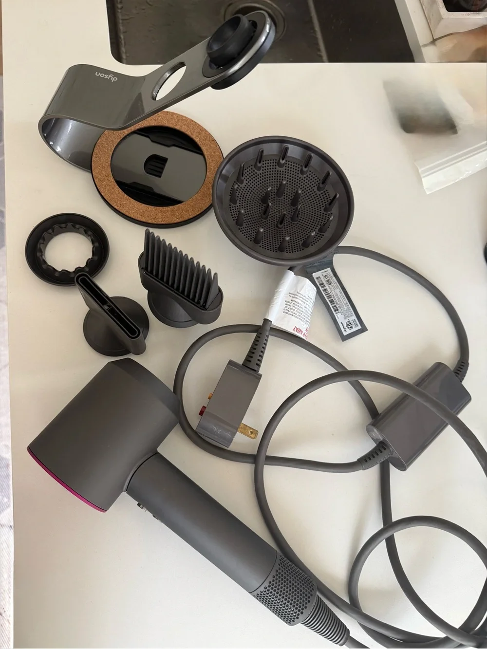Dyson hair dryer with diffuser and cord in charcoal and magenta accents